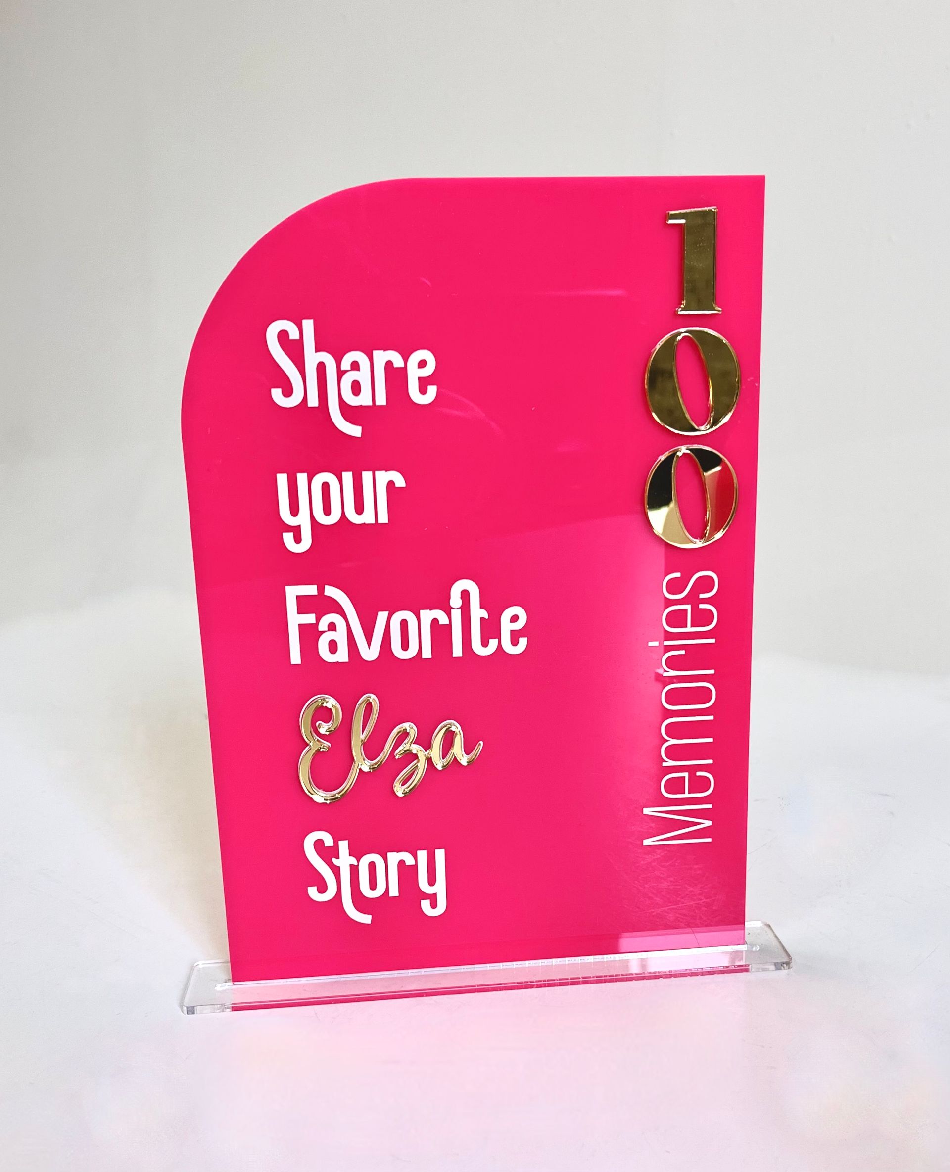 A pink sign that says share your favorite elsa story