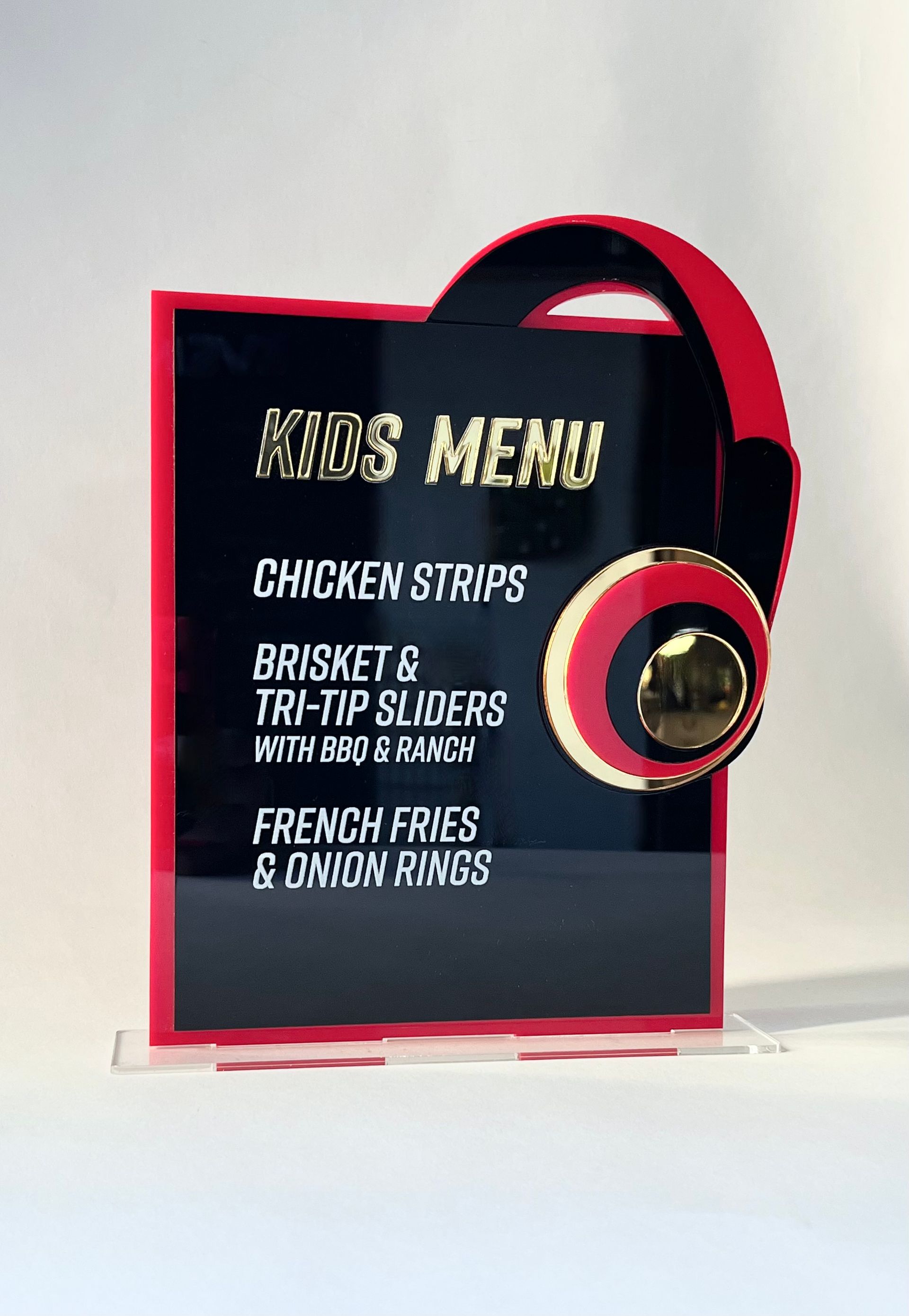 A kids menu with chicken strips and french fries on it