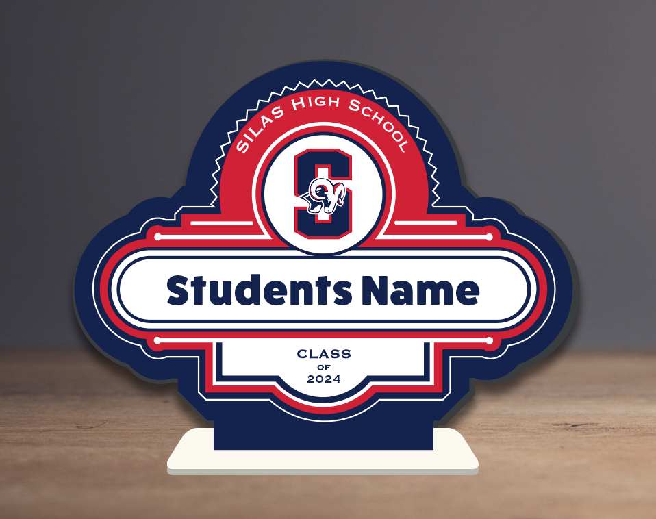 A sign that says students name is on a wooden table