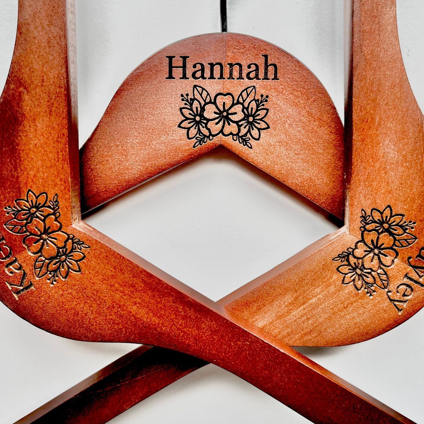 A wooden hanger with the name hannah on it