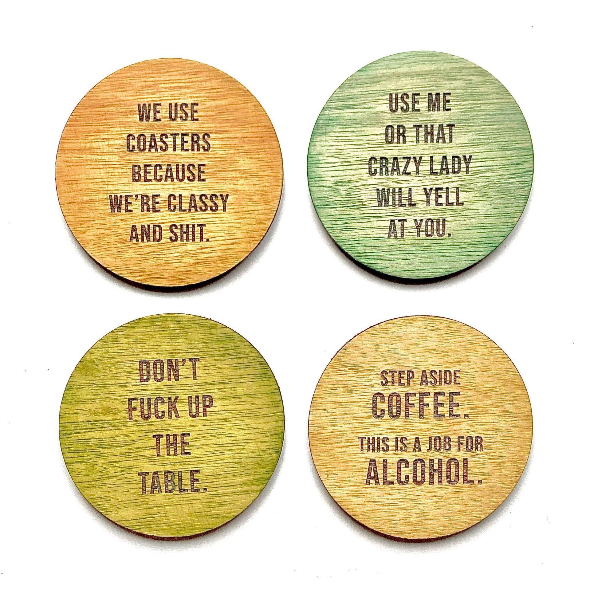 A set of four coasters with different sayings on them