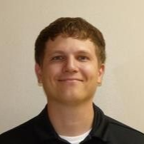 A woman is wearing a stethoscope around her neck and smiling.