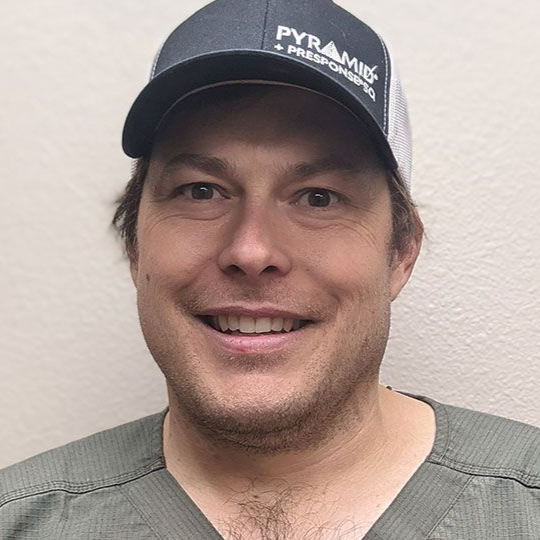 A woman wearing glasses and a black shirt with the letter n on it.