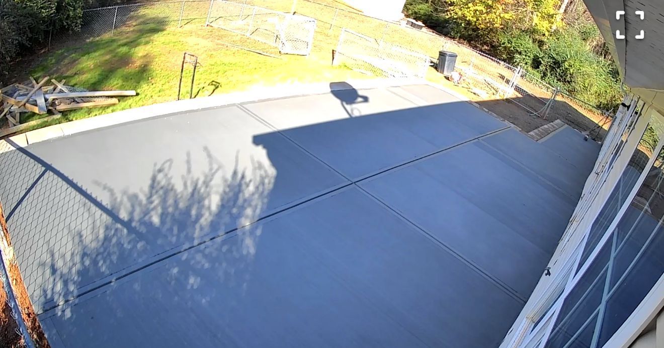 A shadow of a tree is cast on the roof of a house.