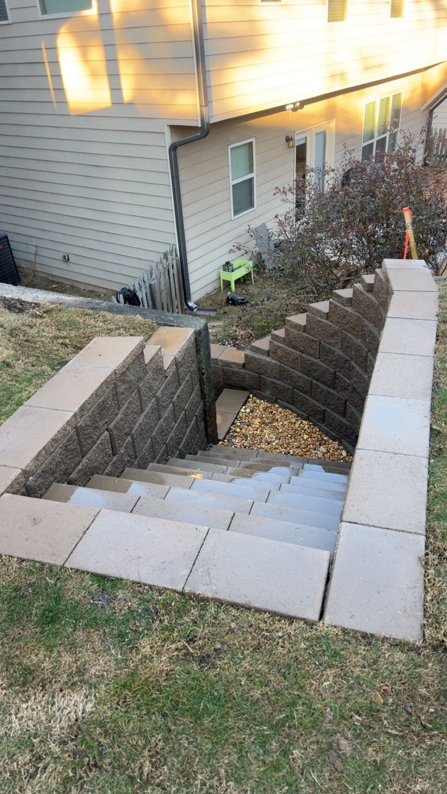 A set of stairs leading up to a basement under a house.