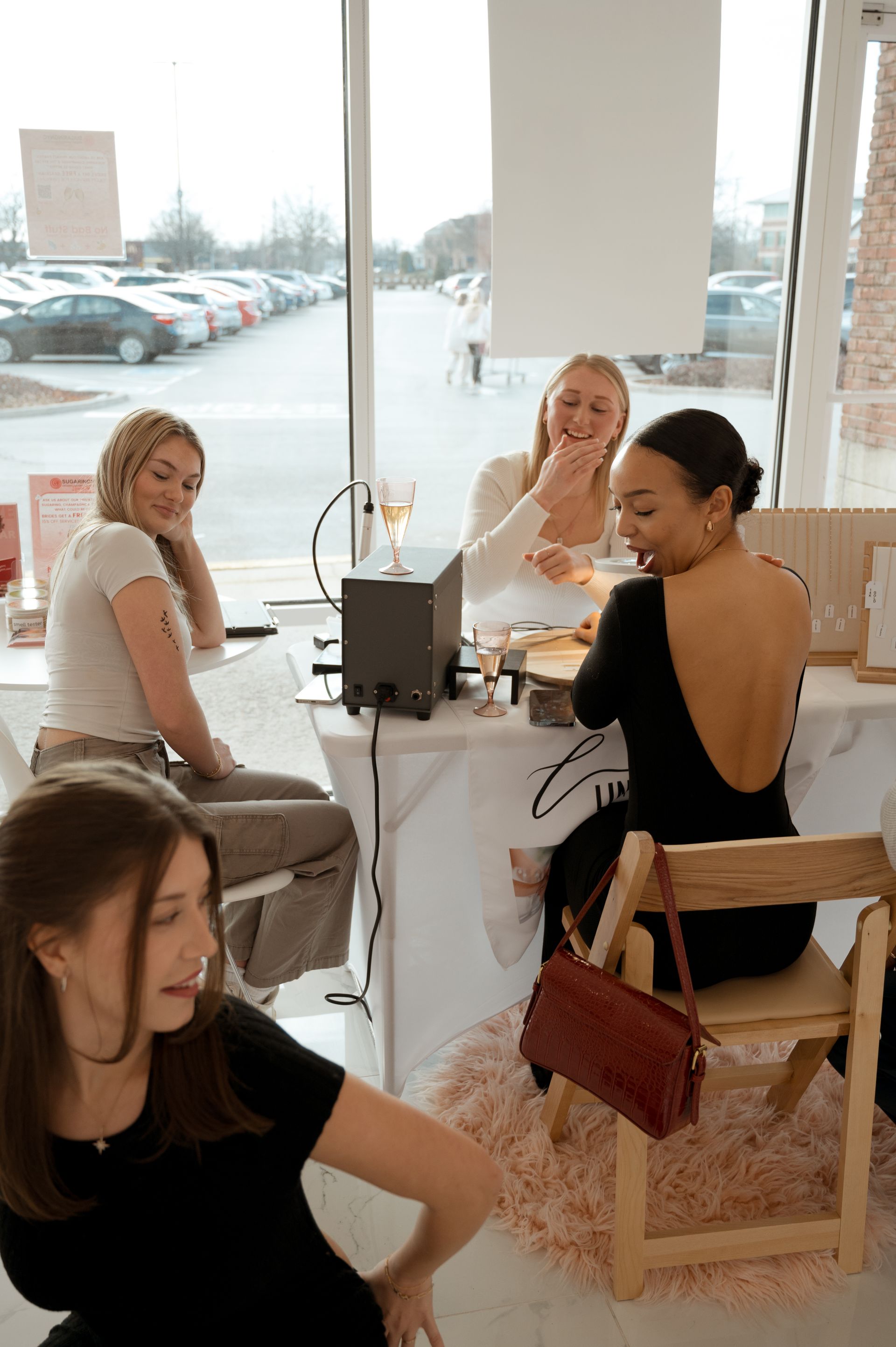 A group of women are sitting at a table in a room.