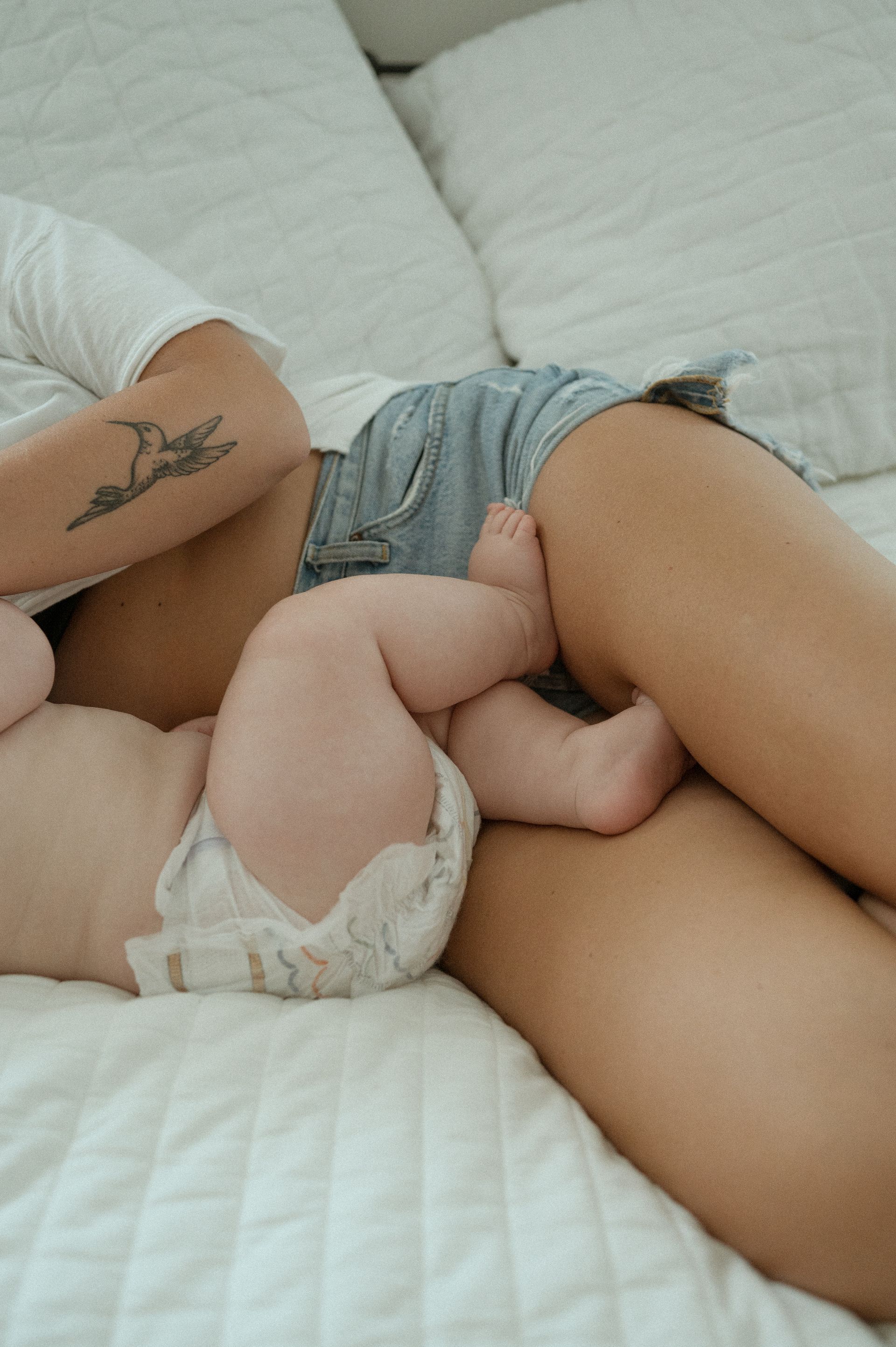 A mom and baby laying in bed