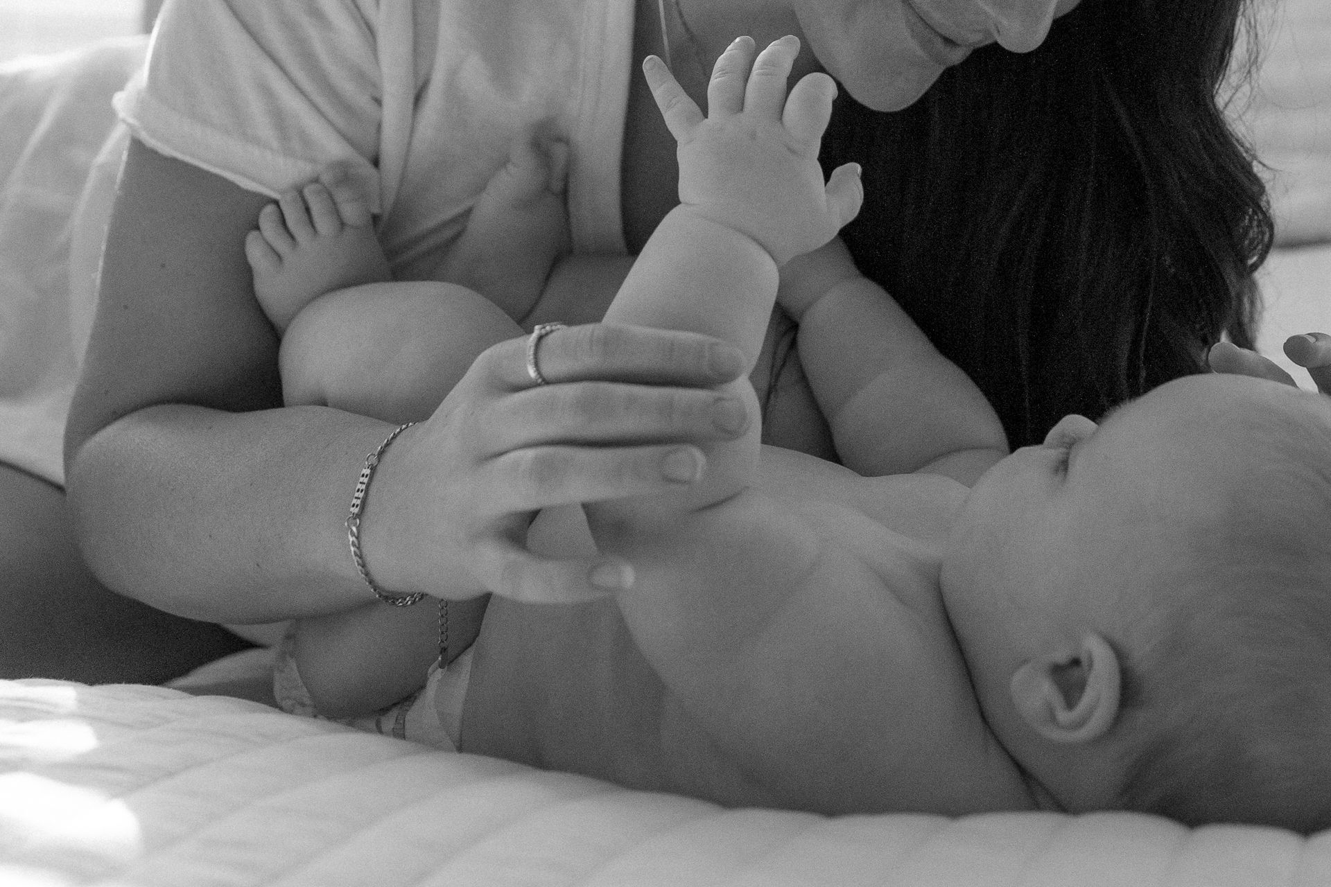 A black and white photo of a woman holding a baby