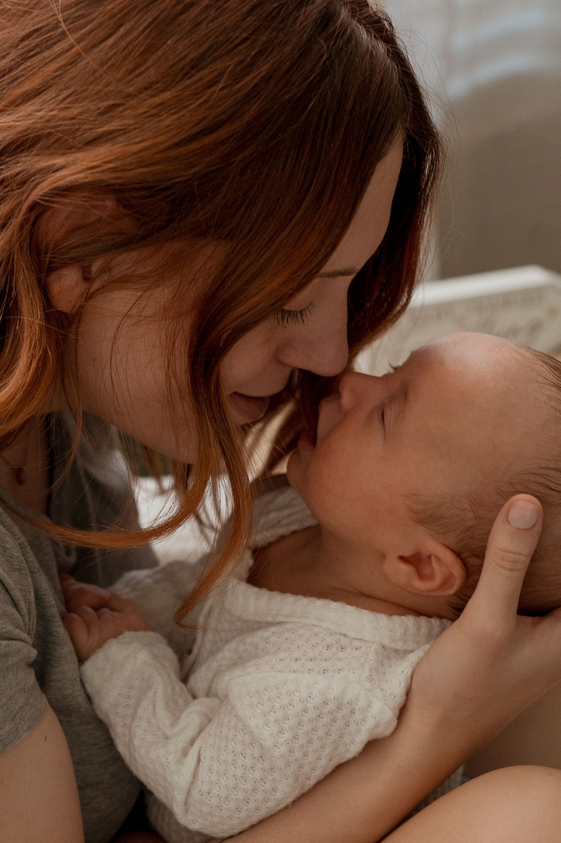 A mother touching noses with her baby
