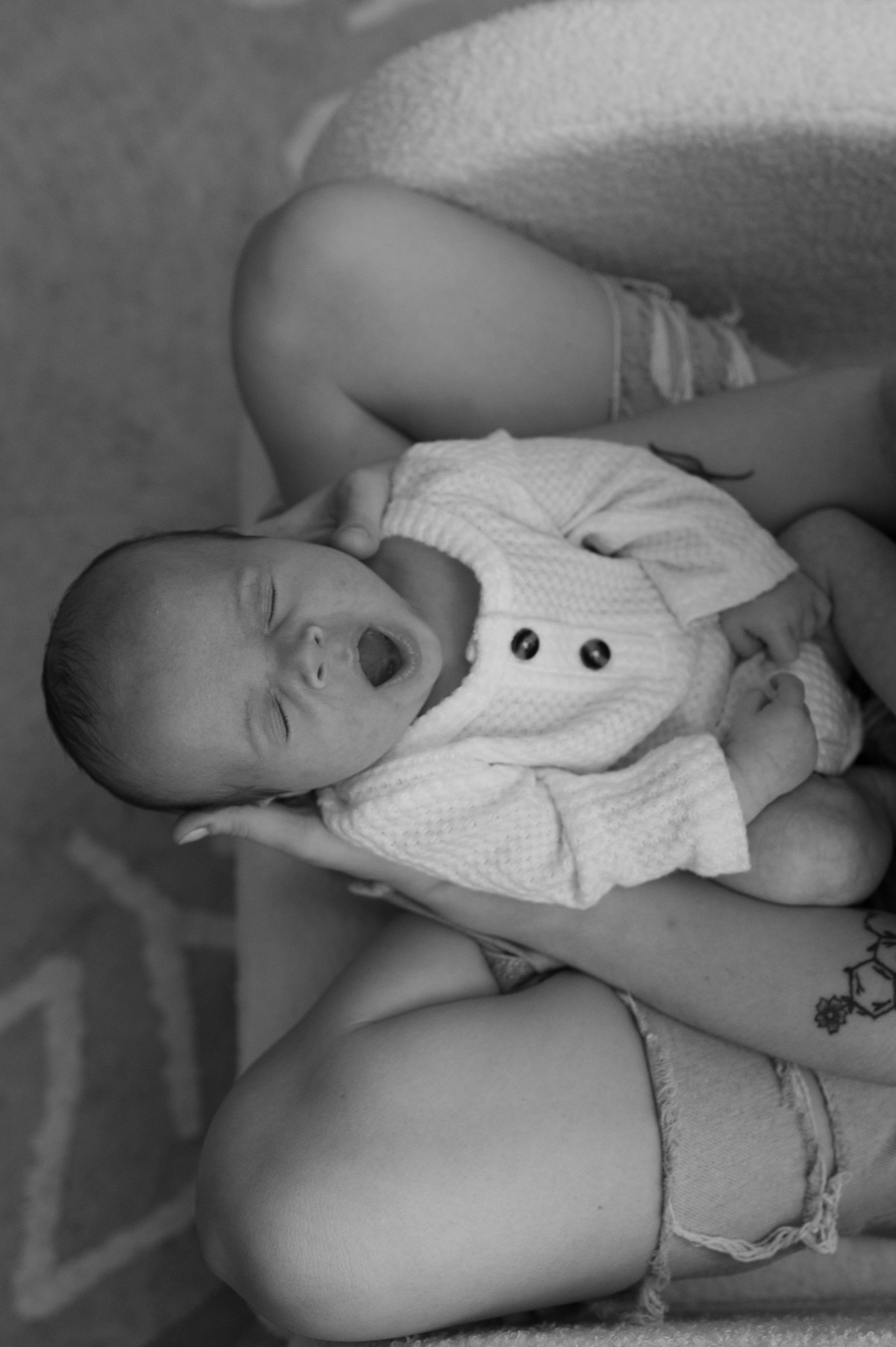 A black and white photo of a woman holding a baby