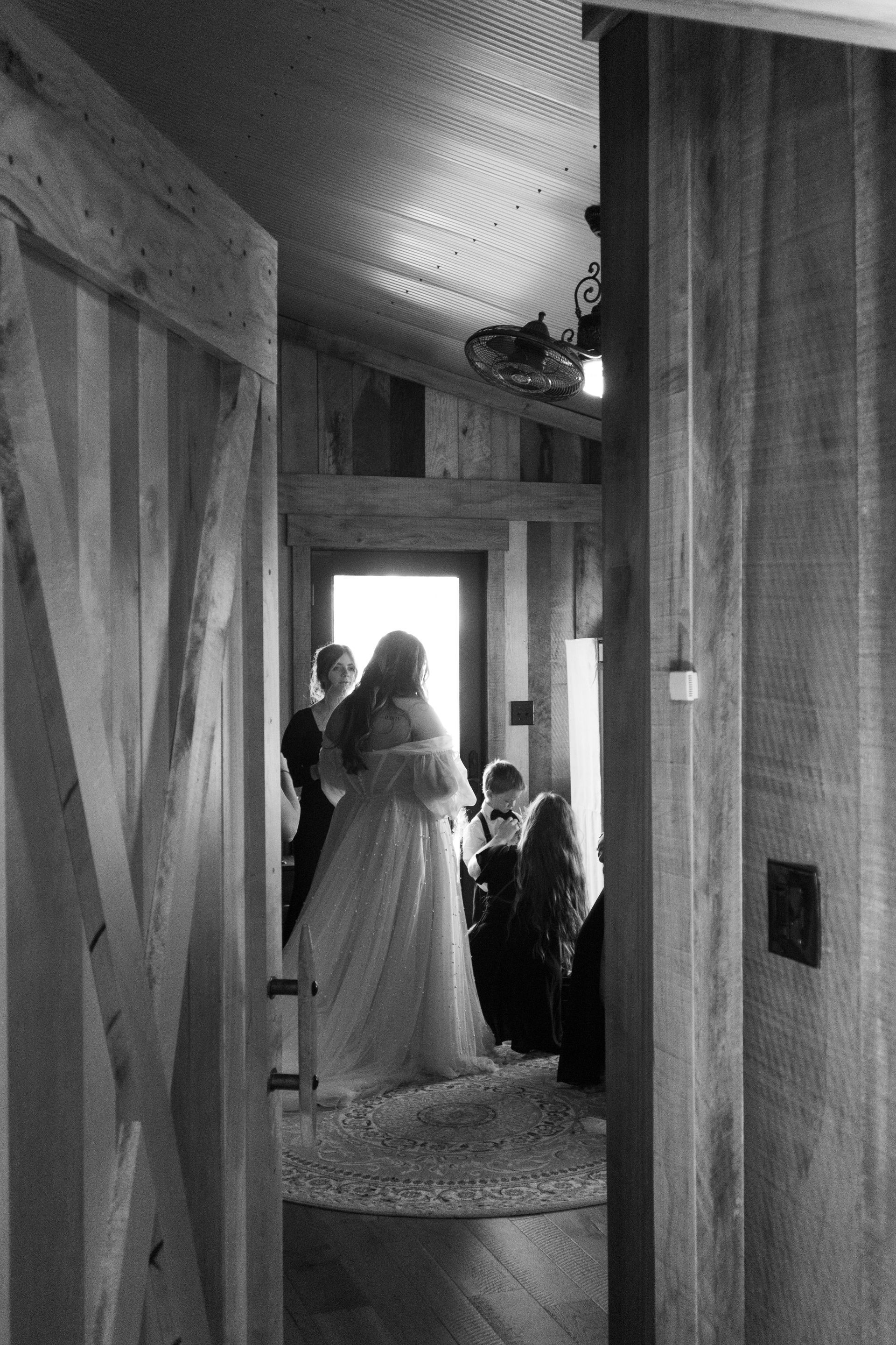 A black and white photo of a bride getting ready for her wedding.