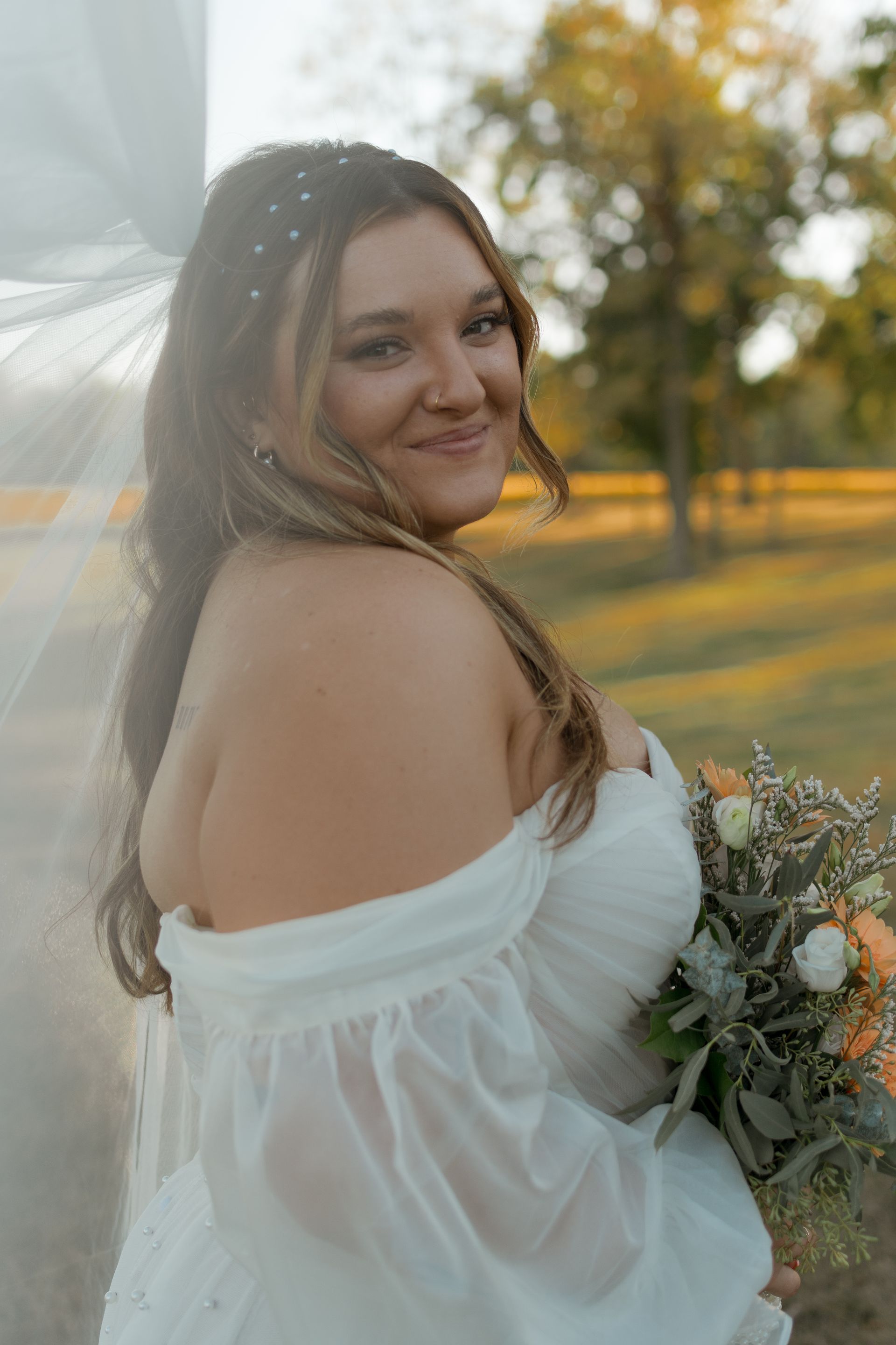 The bride is wearing a white dress and holding a bouquet of flowers.