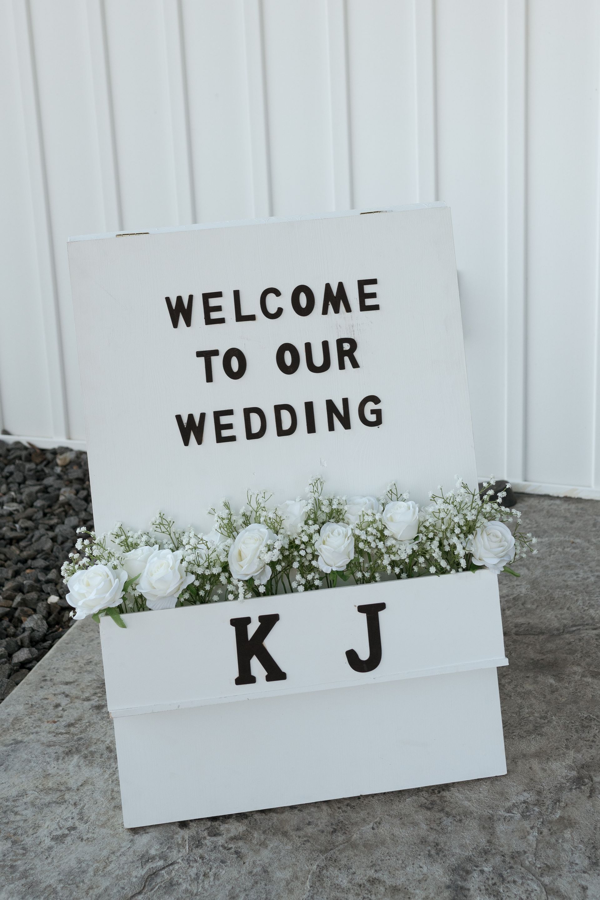 A white sign that says welcome to our wedding