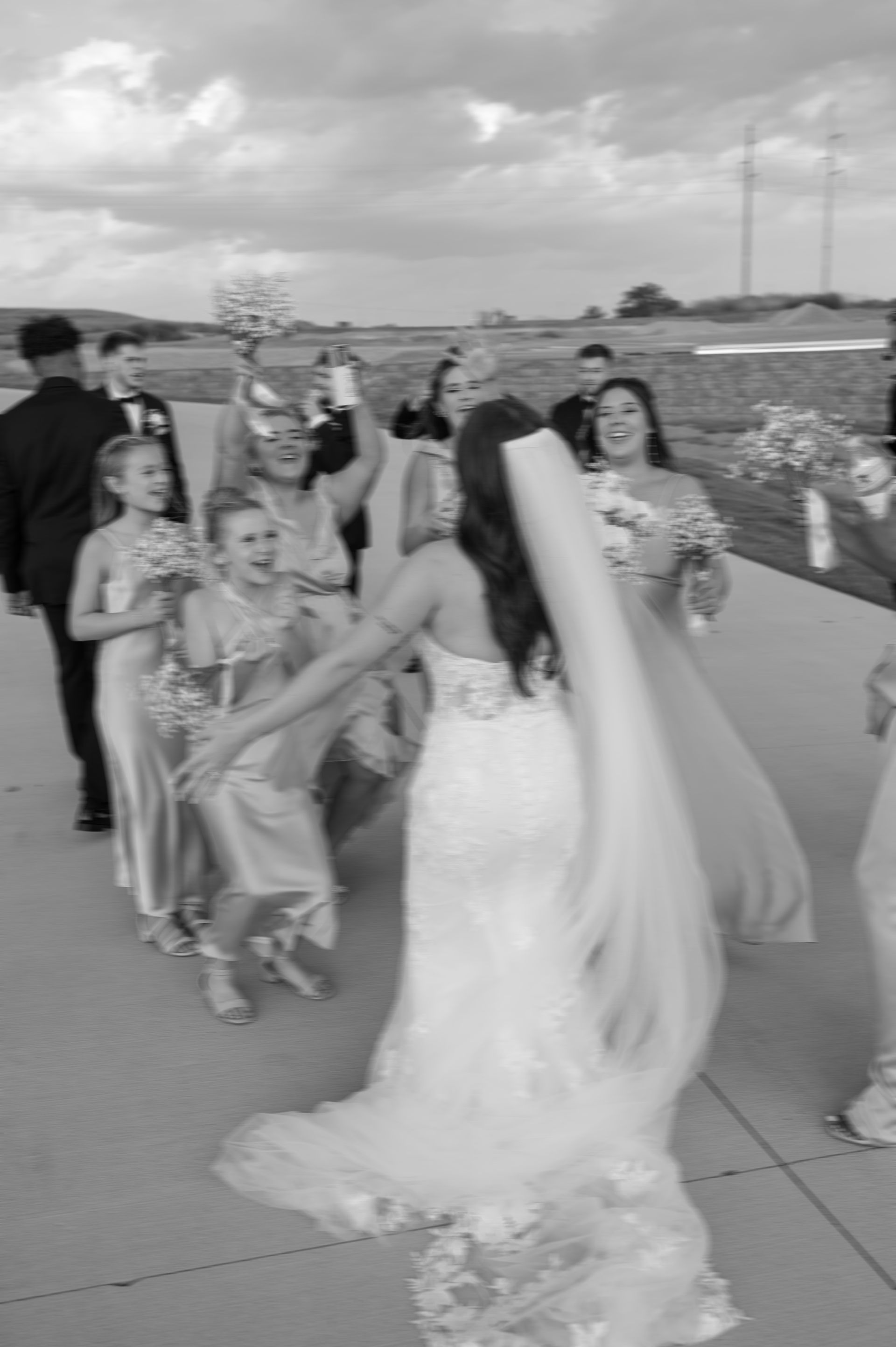 A bride and groom are walking down the aisle with their wedding party.