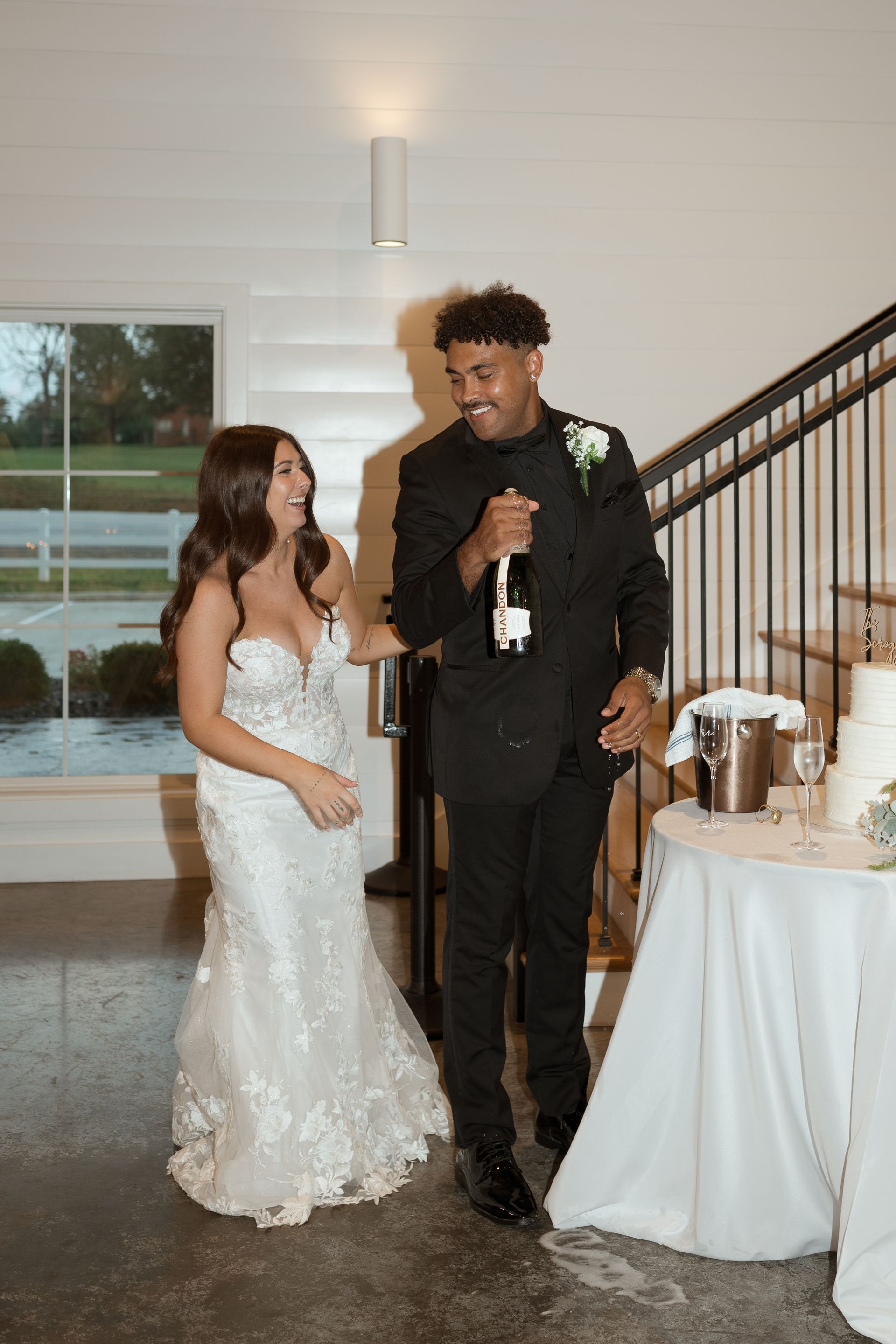 A bride and groom are standing next to each other at a wedding reception.