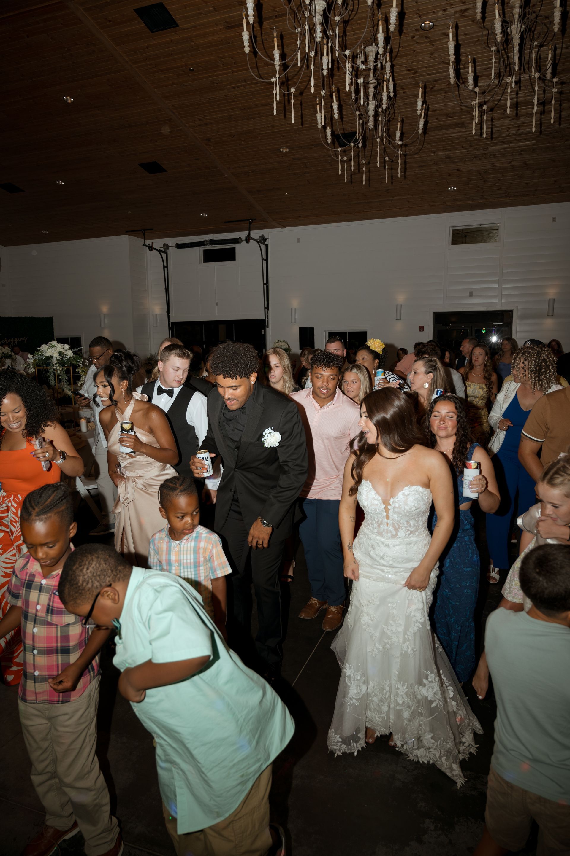 A bride and groom are dancing with their wedding guests