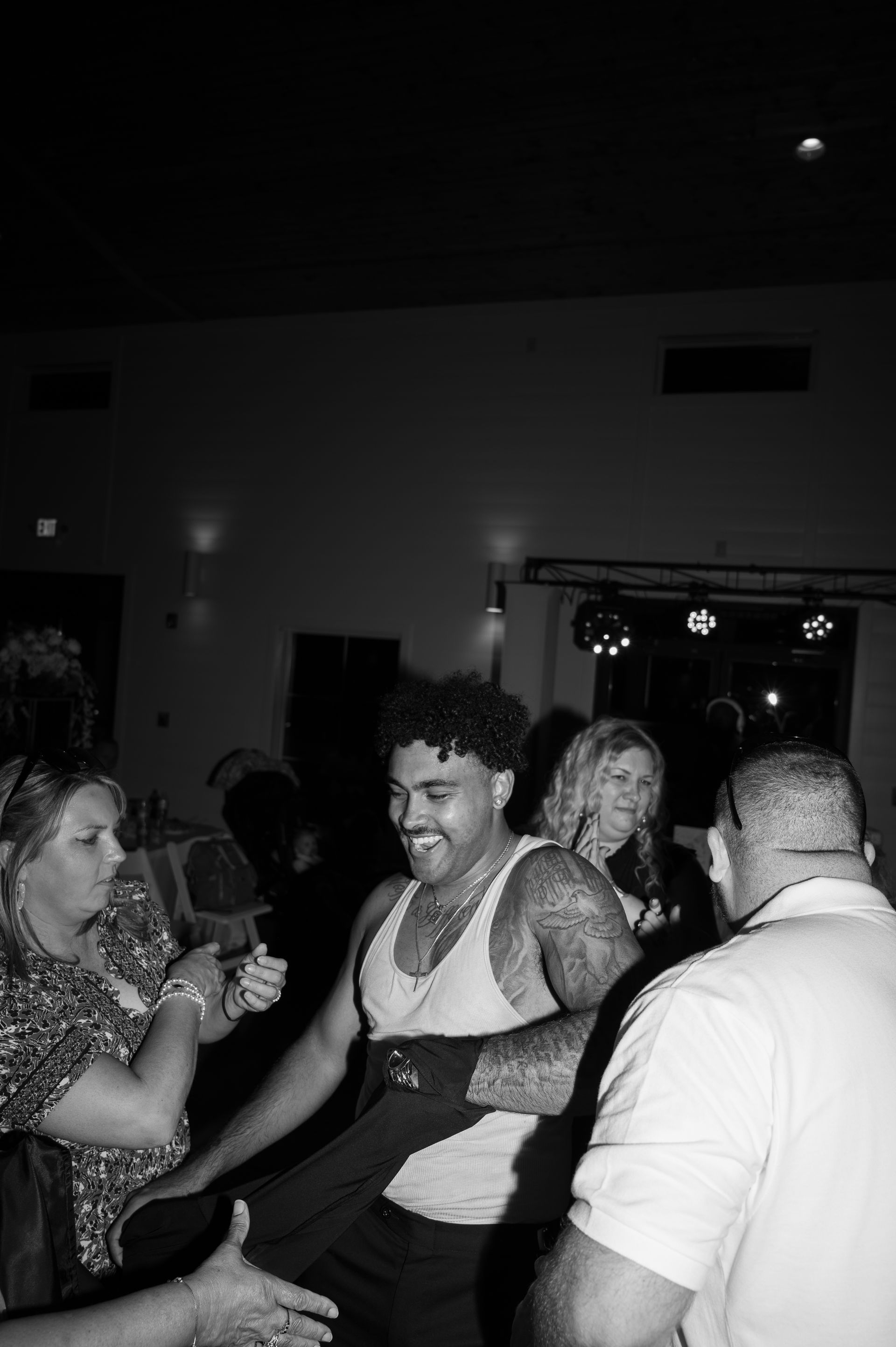 A group of people are dancing in a dark room.