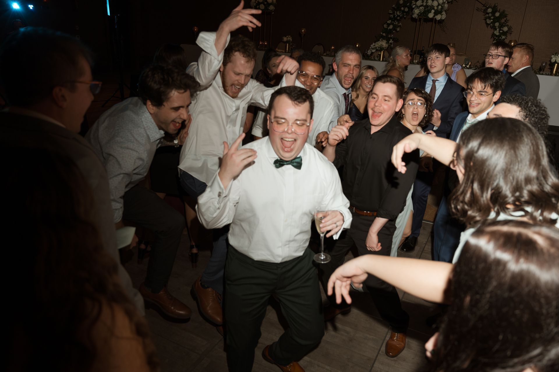 A group of people are dancing together at a party.