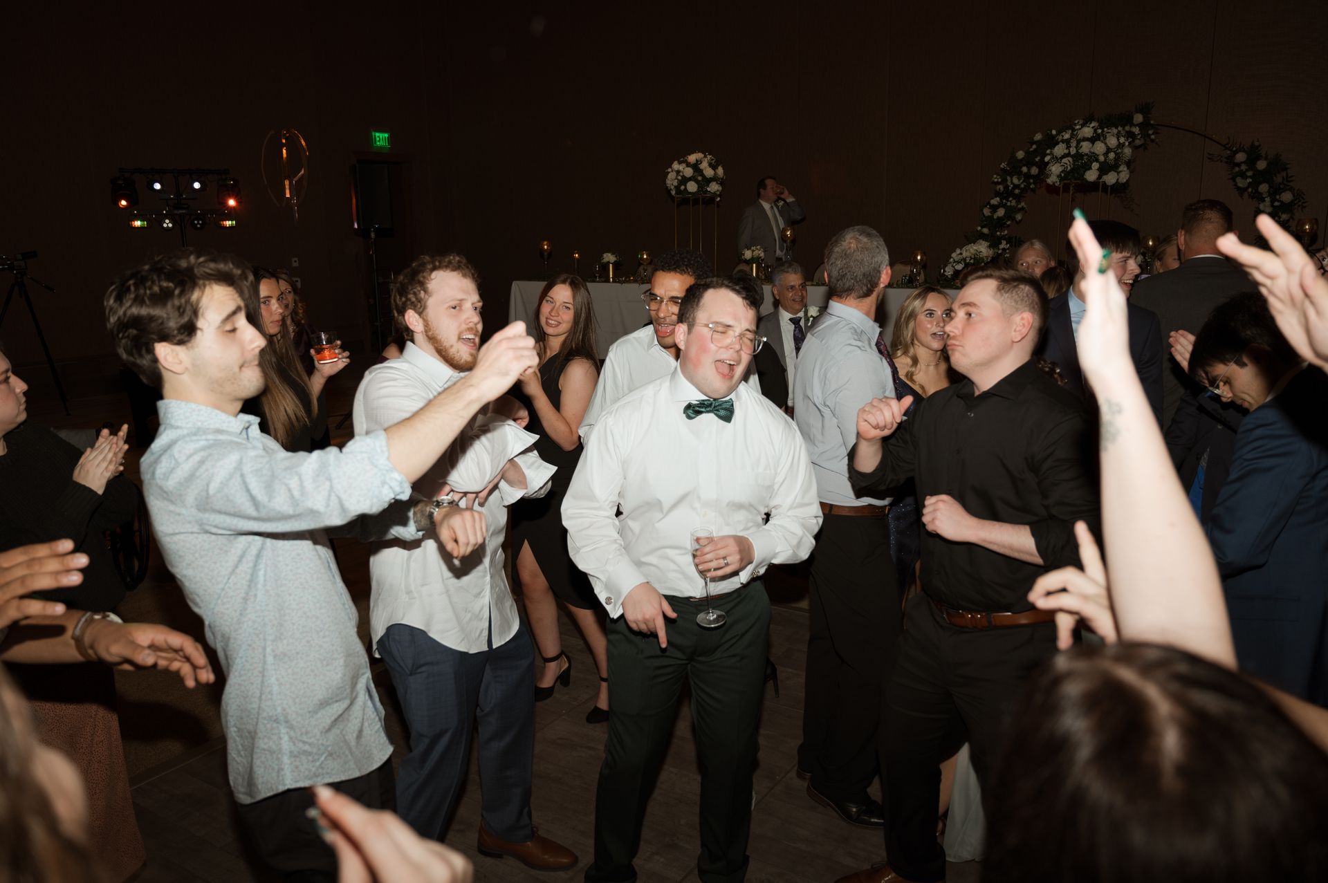 A group of people are dancing together at a party.