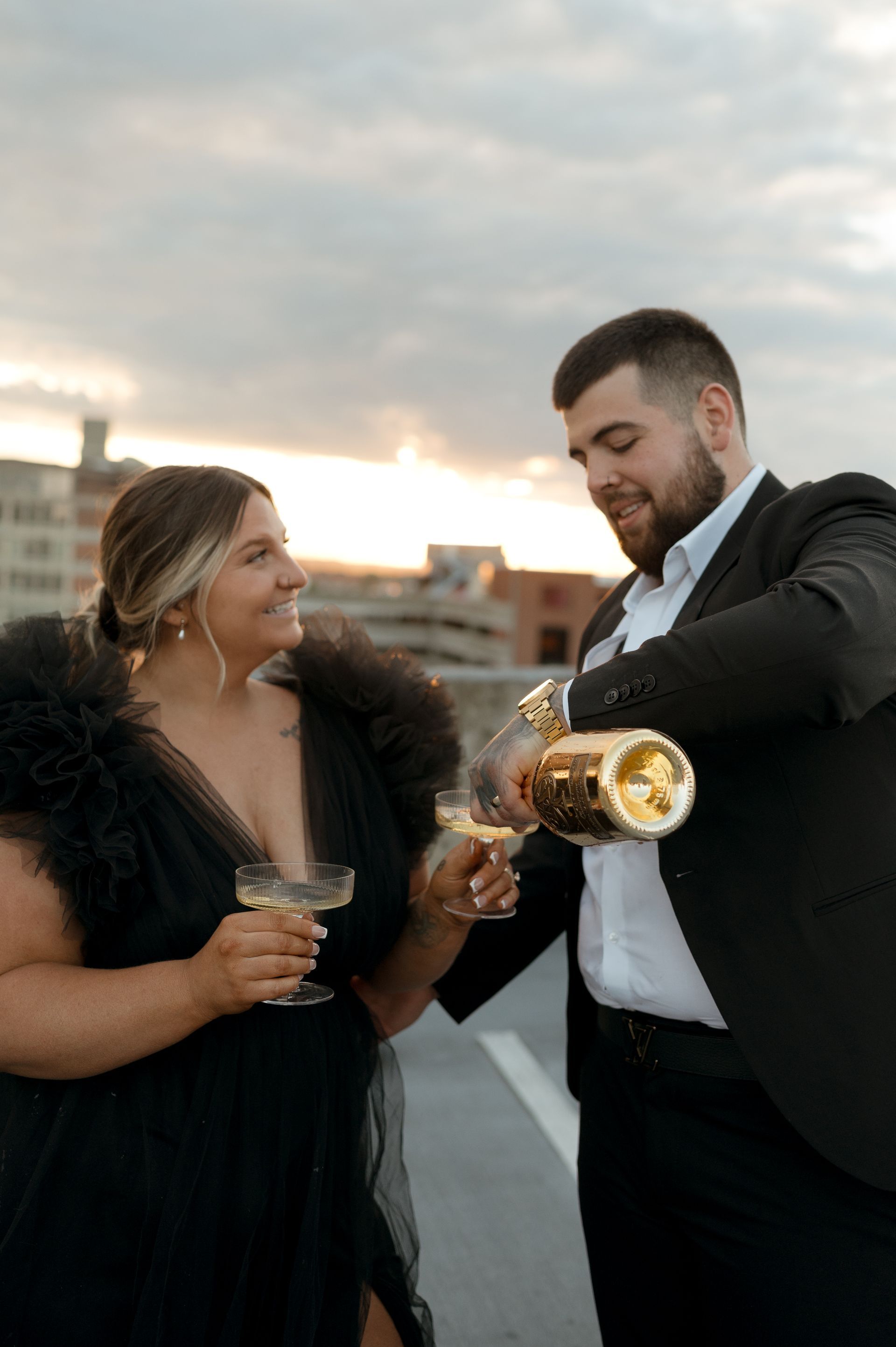 A man is pouring champagne into a woman 's glass.