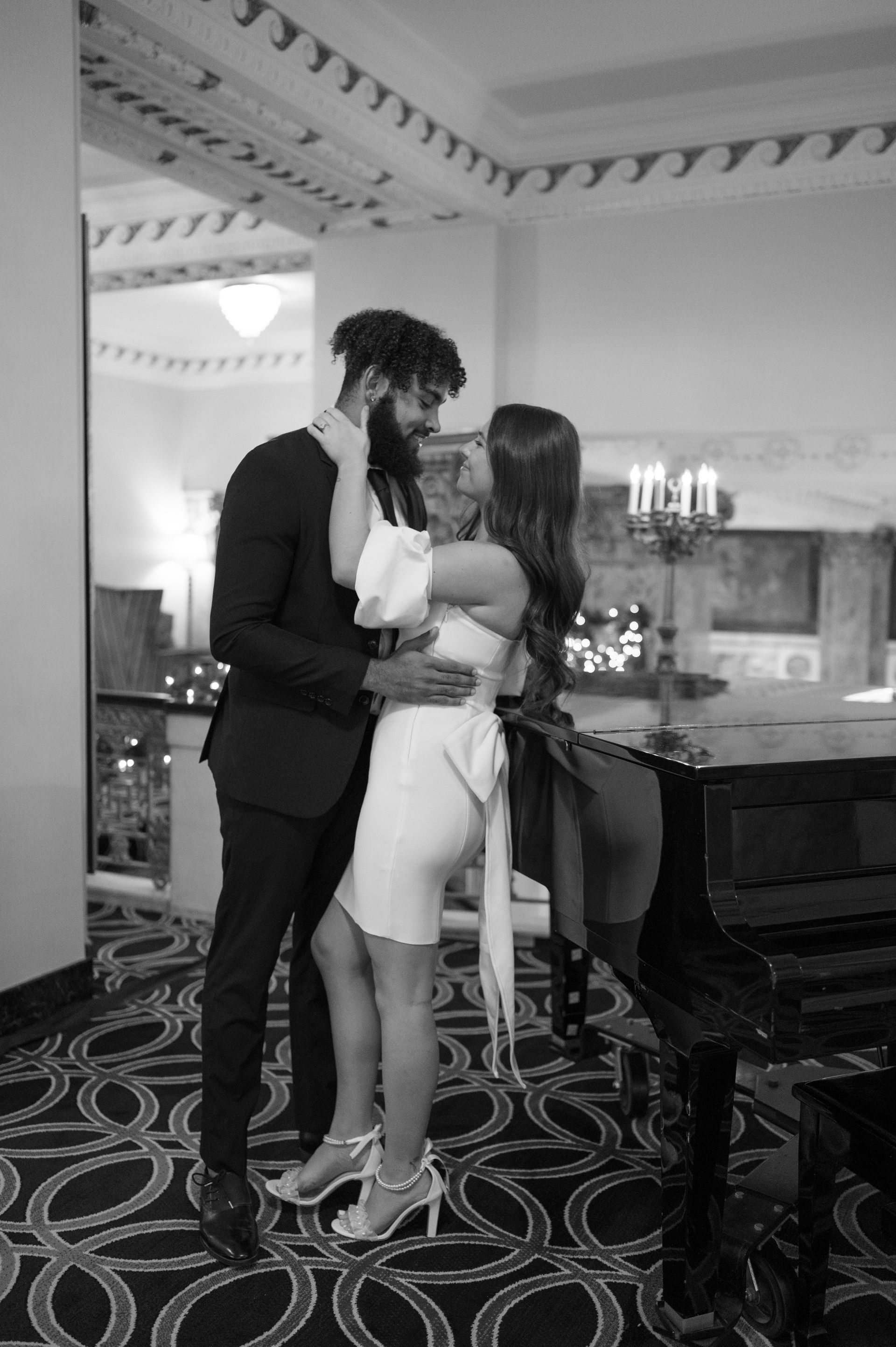 A black and white photo of a man and woman kissing