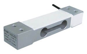 A weight sensor with a wire attached to it is sitting on a white surface.