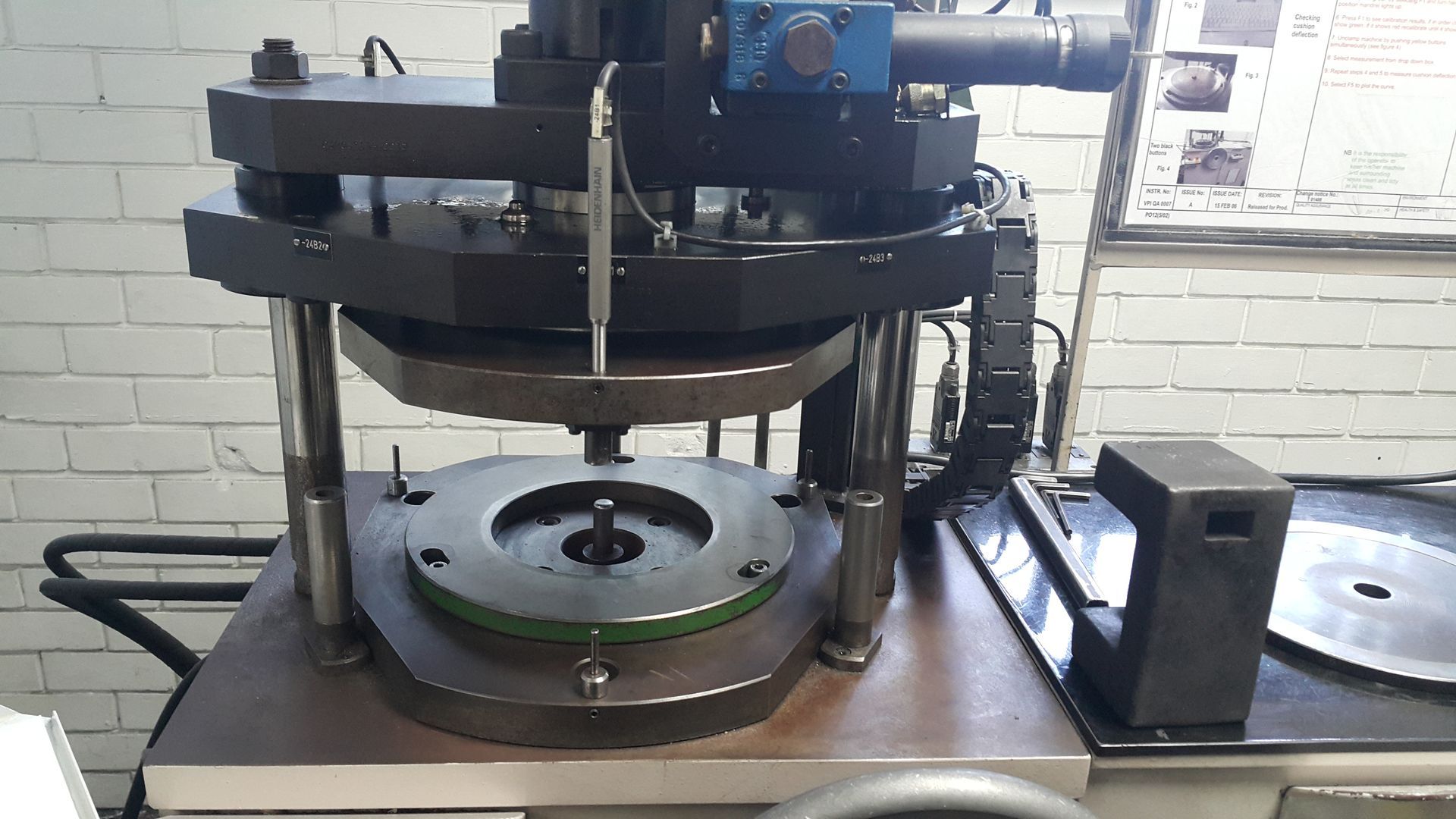 A machine is sitting on a table in front of a brick wall.