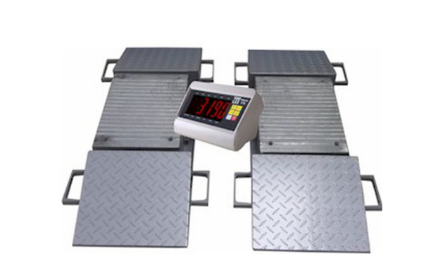 A digital scale is sitting on top of a metal platform