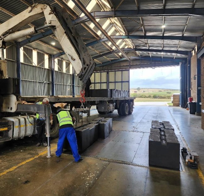 A man is working on a truck in a warehouse