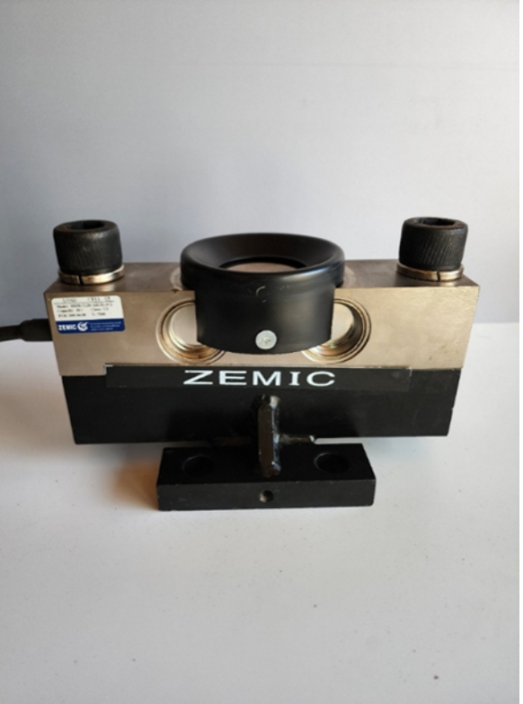 A device that says zemic on it is sitting on a table.