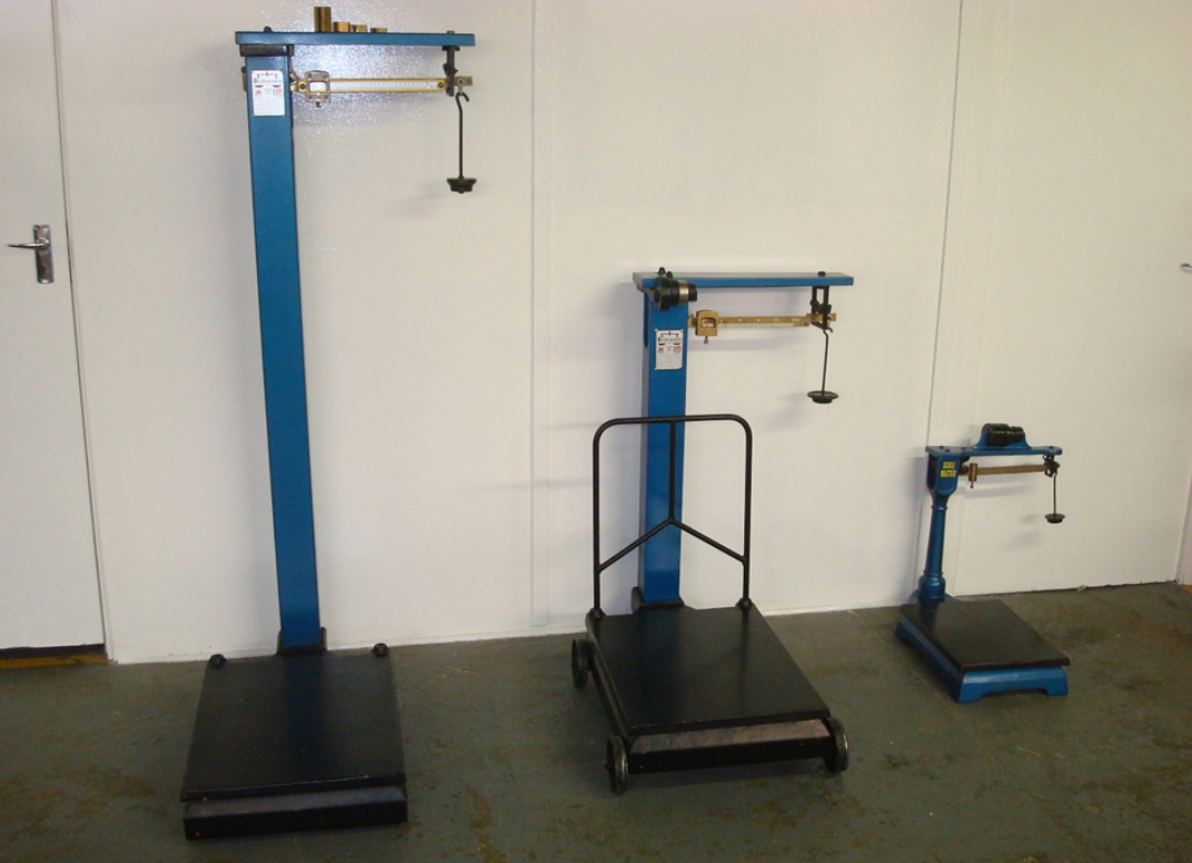 Three scales are in a room with a white wall