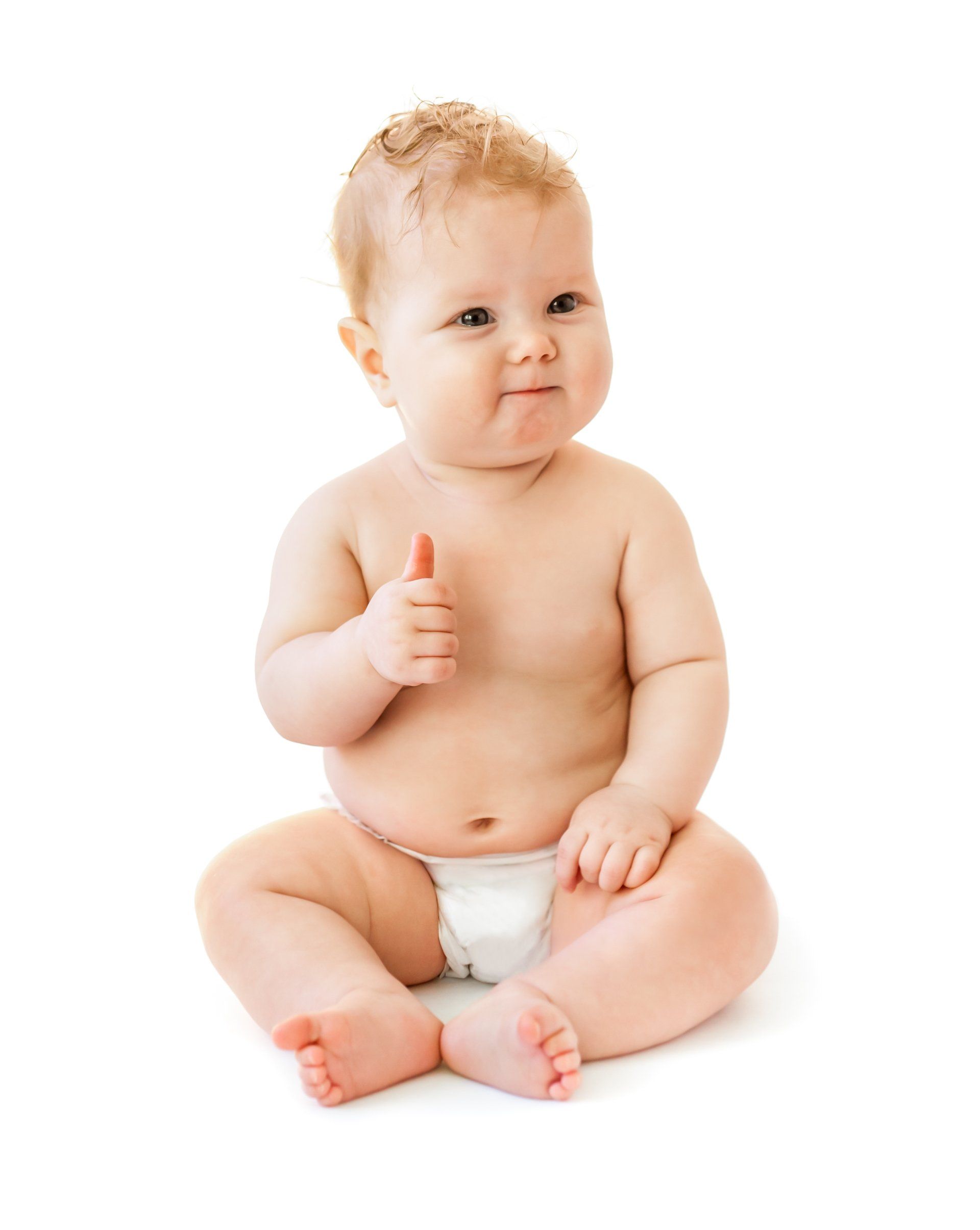 A baby in a diaper is sitting on the floor and giving a thumbs up.