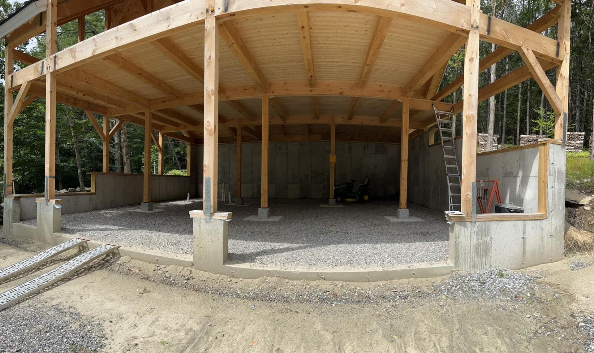 A large wooden structure is being built in the middle of a dirt field.