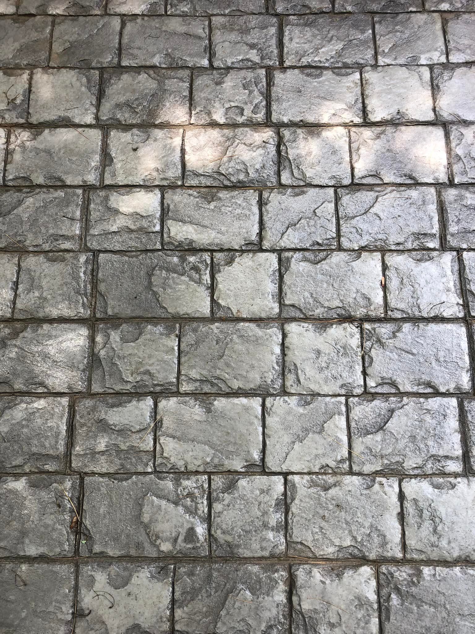 A close up of a brick floor with a lot of bricks