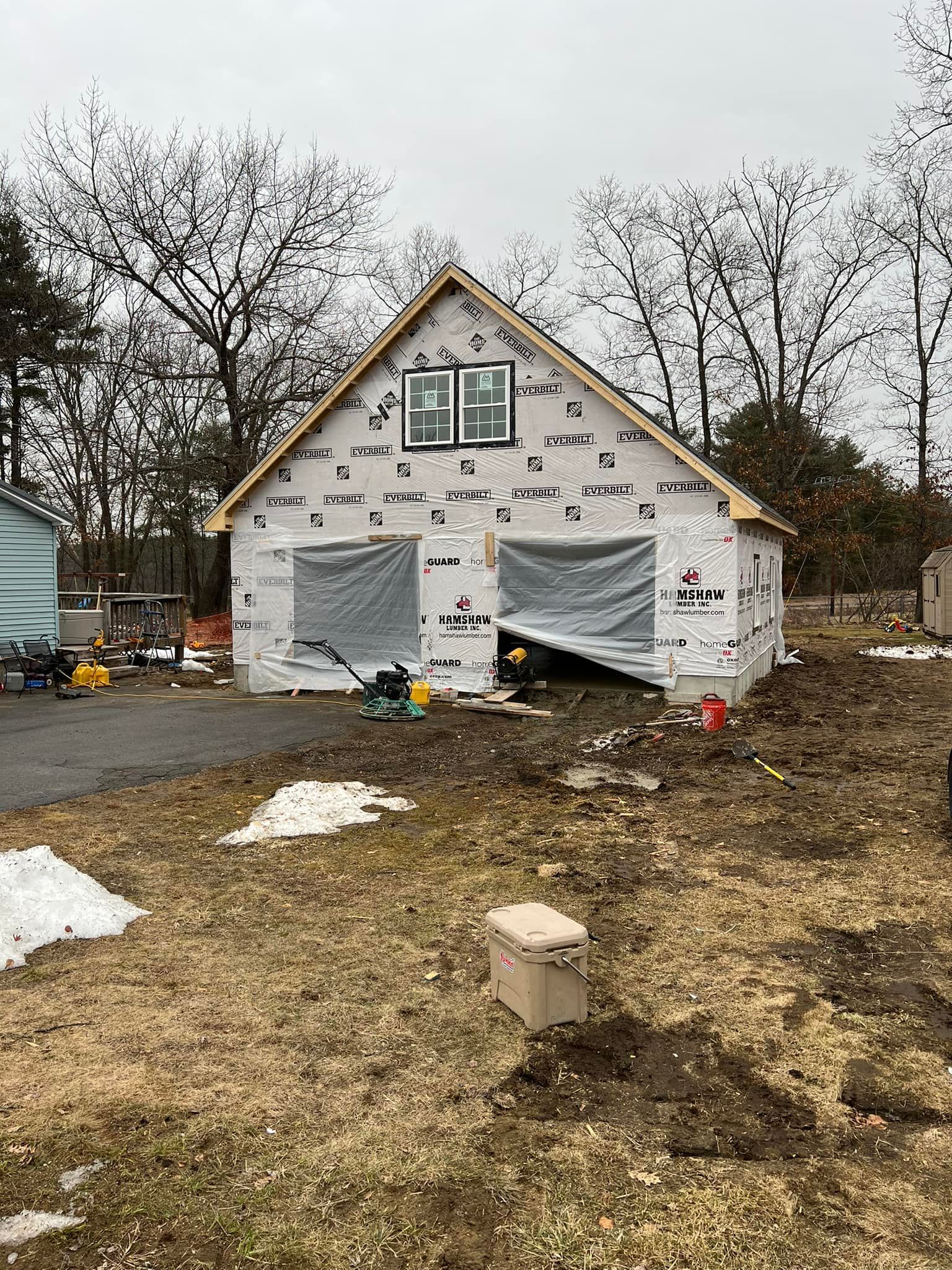 A house is being built in the middle of a field.