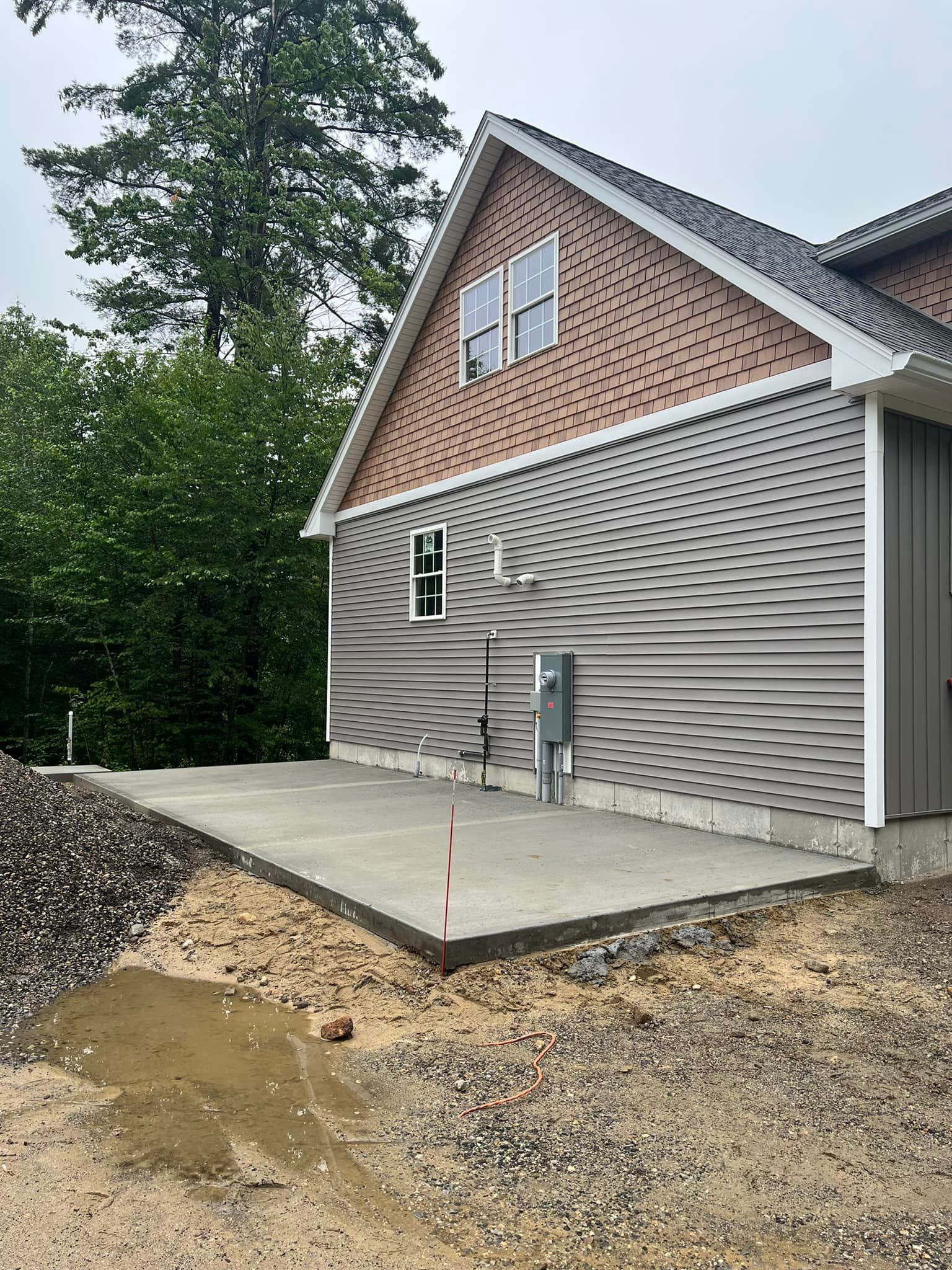 A large house with a concrete driveway in front of it.
