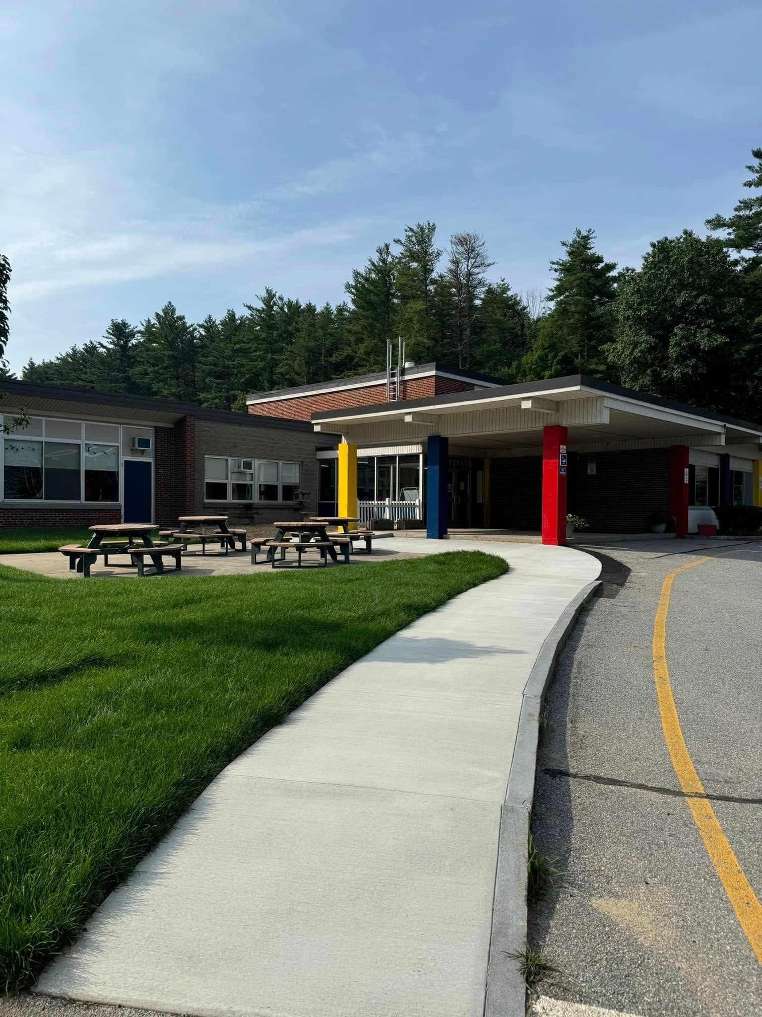 A school with a concrete walkway leading to it