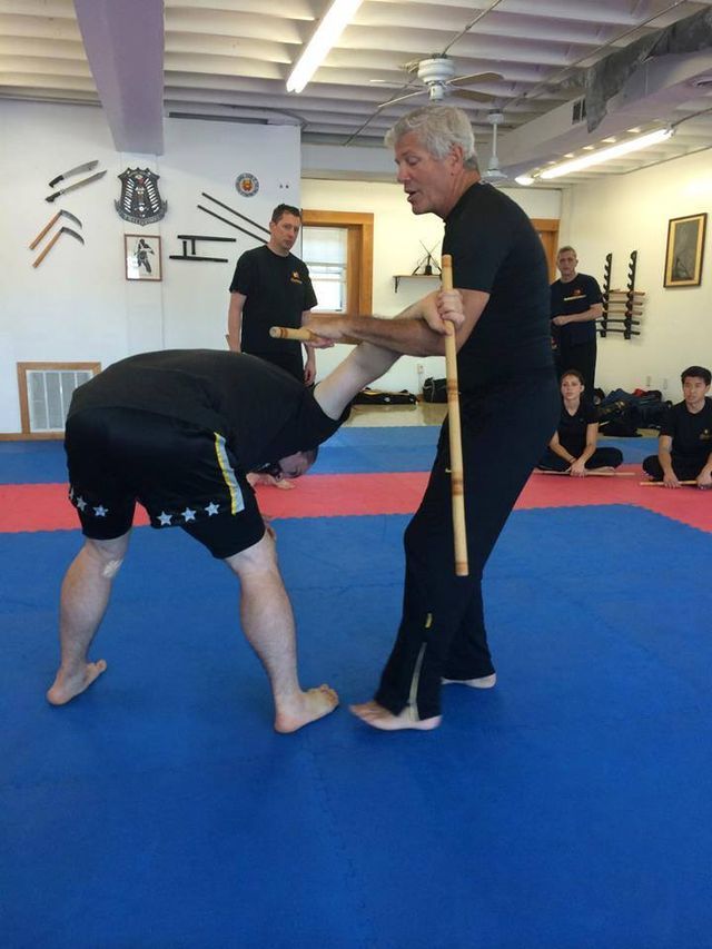 a group of men are practicing martial arts in a gym