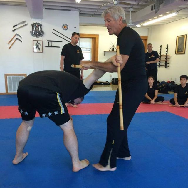 a group of men are practicing martial arts in a gym