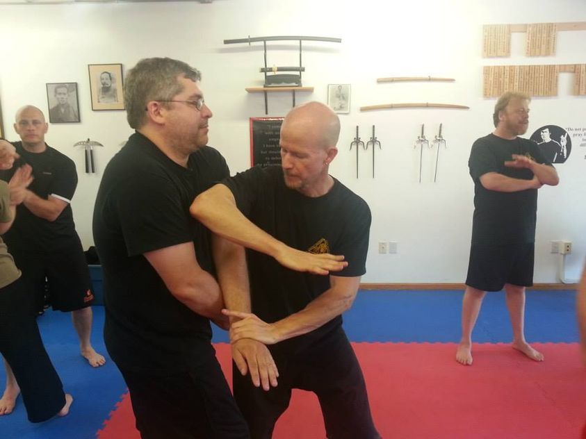 a group of men are practicing martial arts in a gym