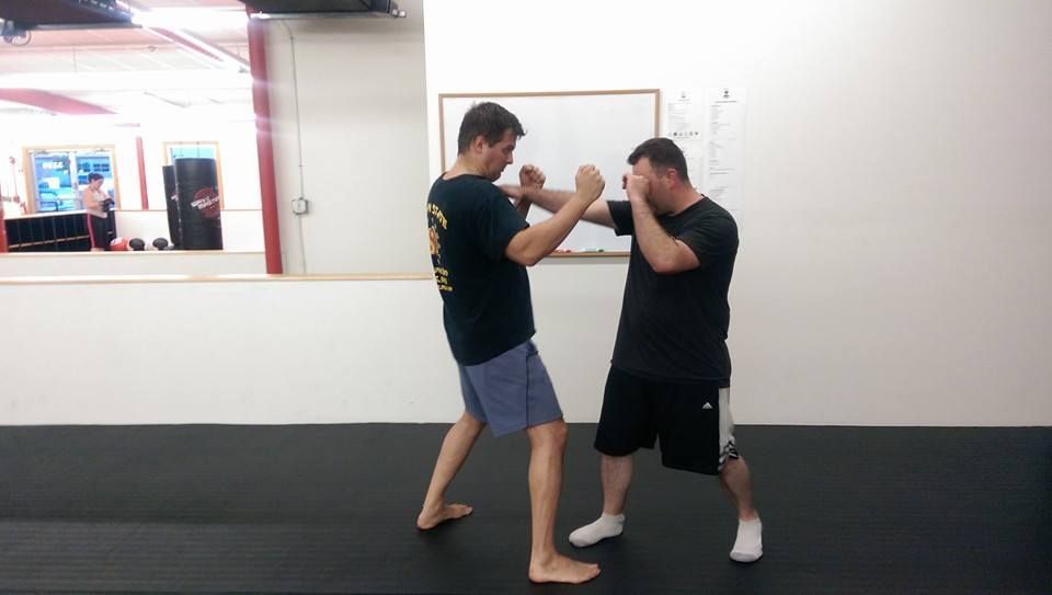 two male partners, one man is punching and the other is blocking