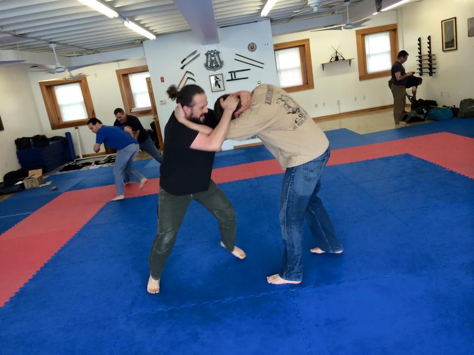 a group of people are practicing martial arts in a gym