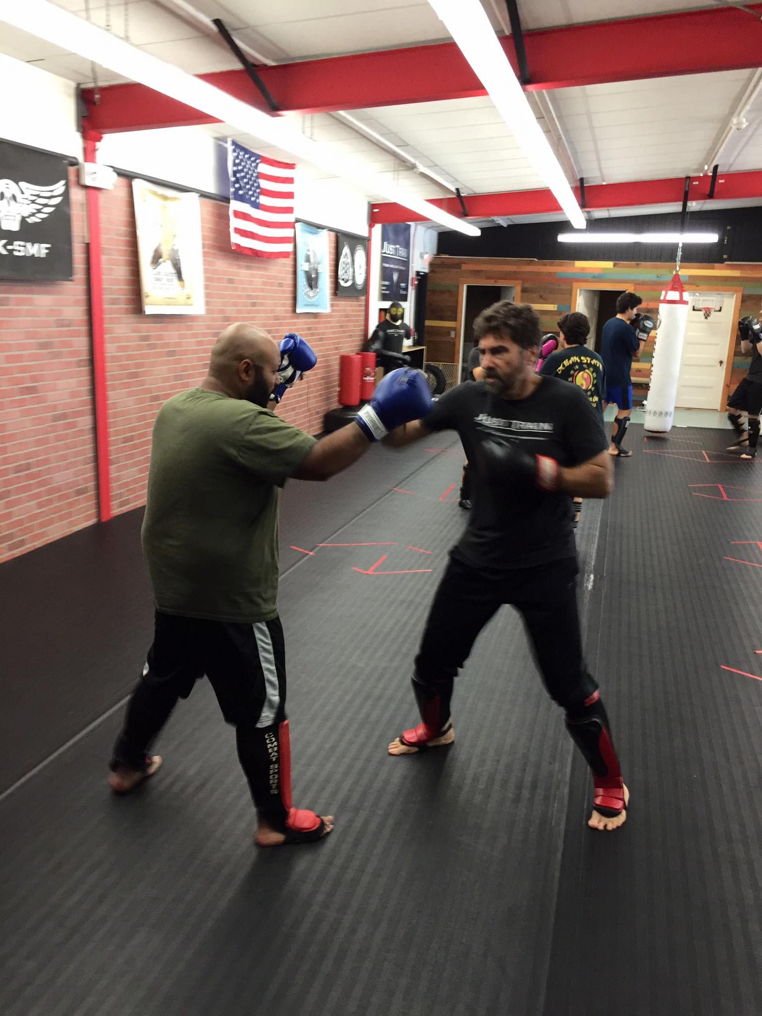 a group of men are boxing in a gym .