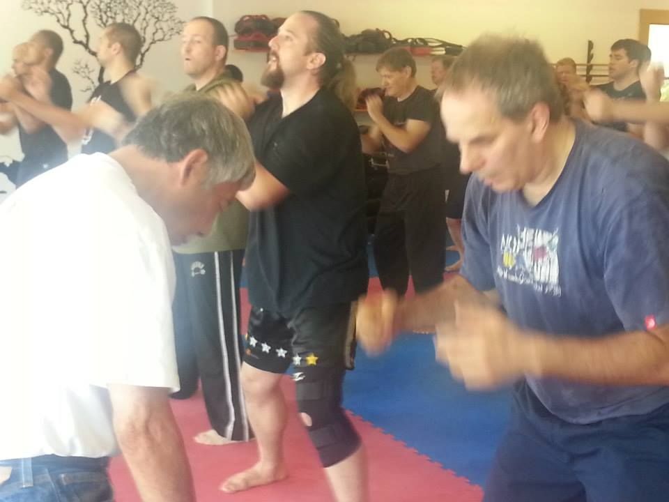 a group of men are practicing martial arts in a gym