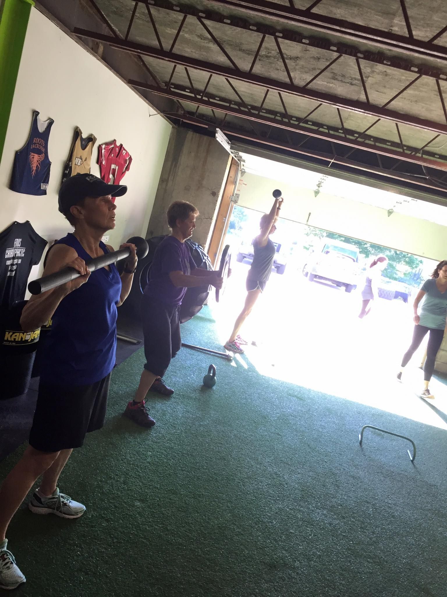 a group of people are doing exercises in a gym .