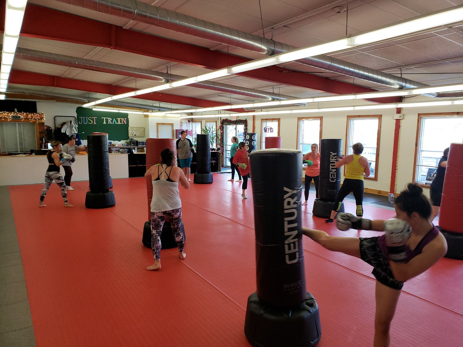 a group of people are practicing martial arts in a gym .