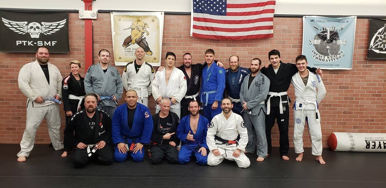 a group of people are posing for a picture in a gym .