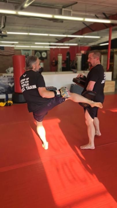 a group of people are practicing martial arts in a gym