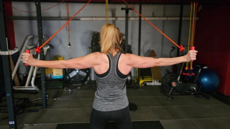 a group of people holding kettlebells in a gym