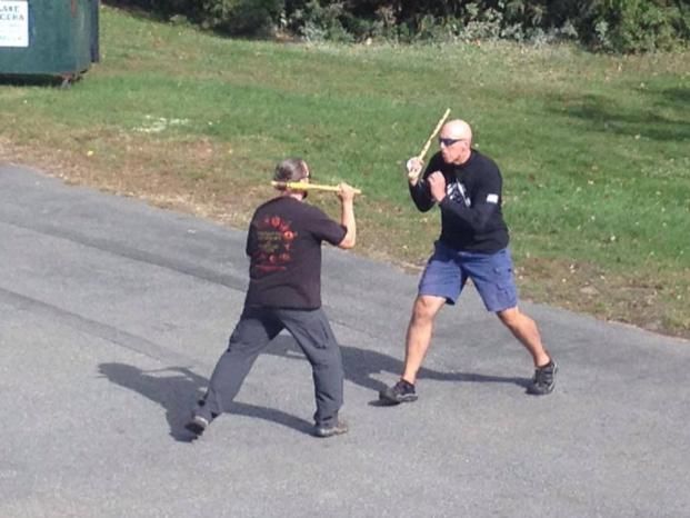 a group of men are practicing martial arts in a gym